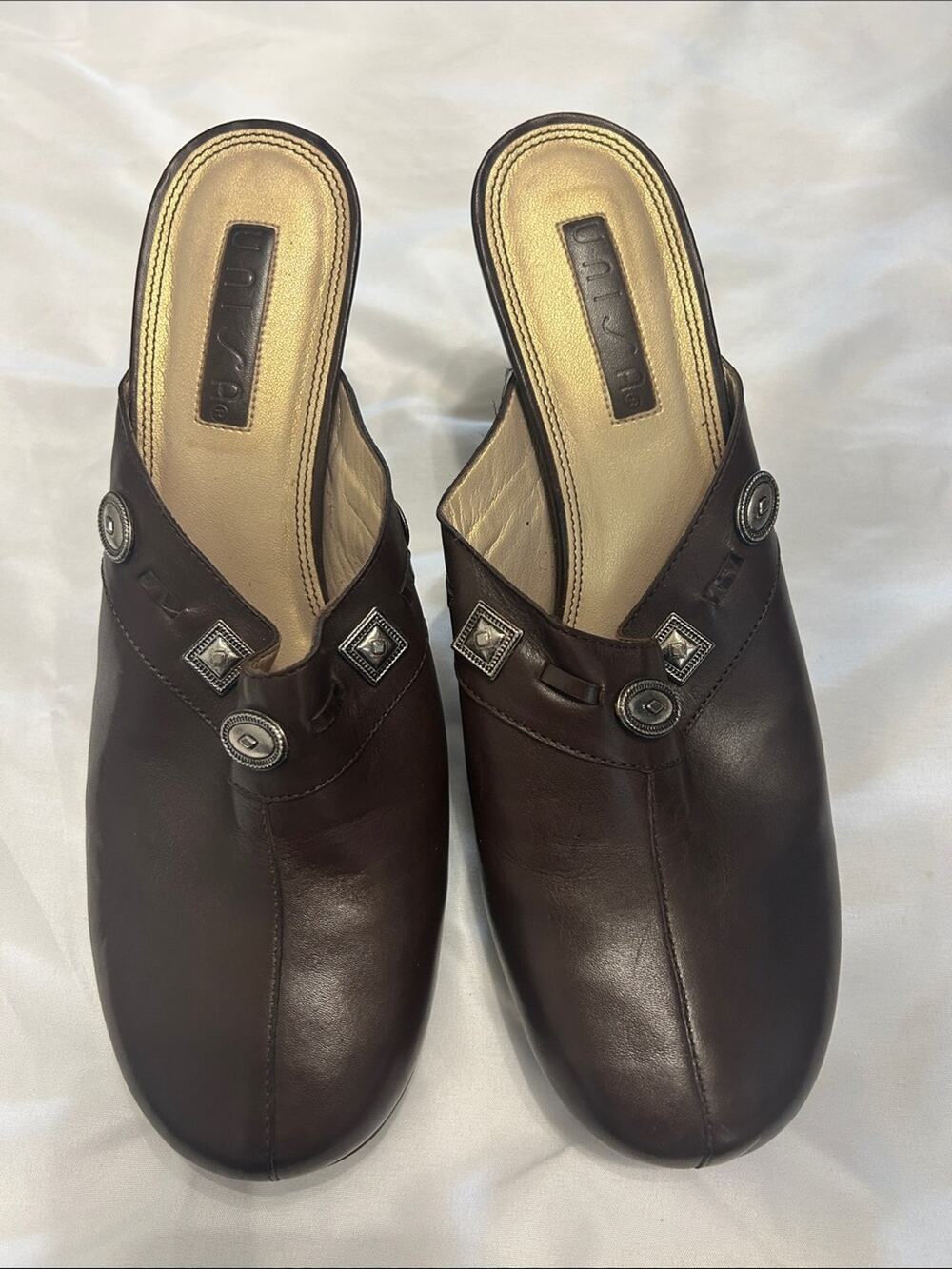 Unisa Dark Brown Leather Slip-On Mules with Decorative Metal Accents